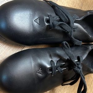 Black Capezio  lace up tap shoes.